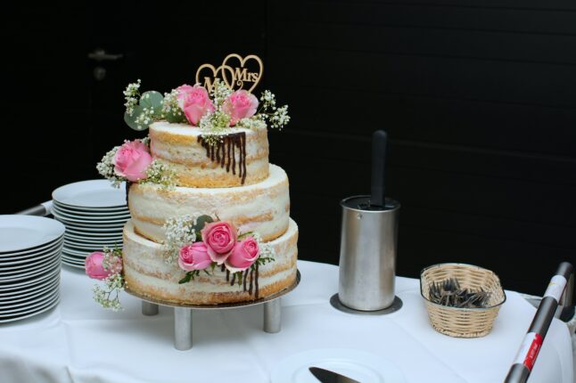 3 layer cake with pink flowers on top