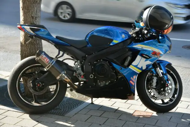 a motorcycle parked next to a tree